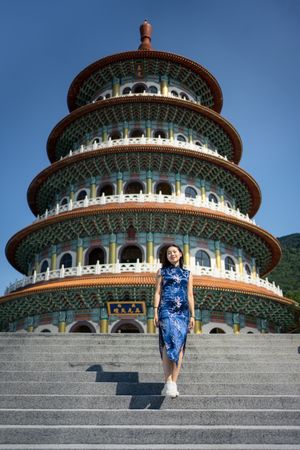 Woman in dress standing next to Wuji Tianyuan Temple