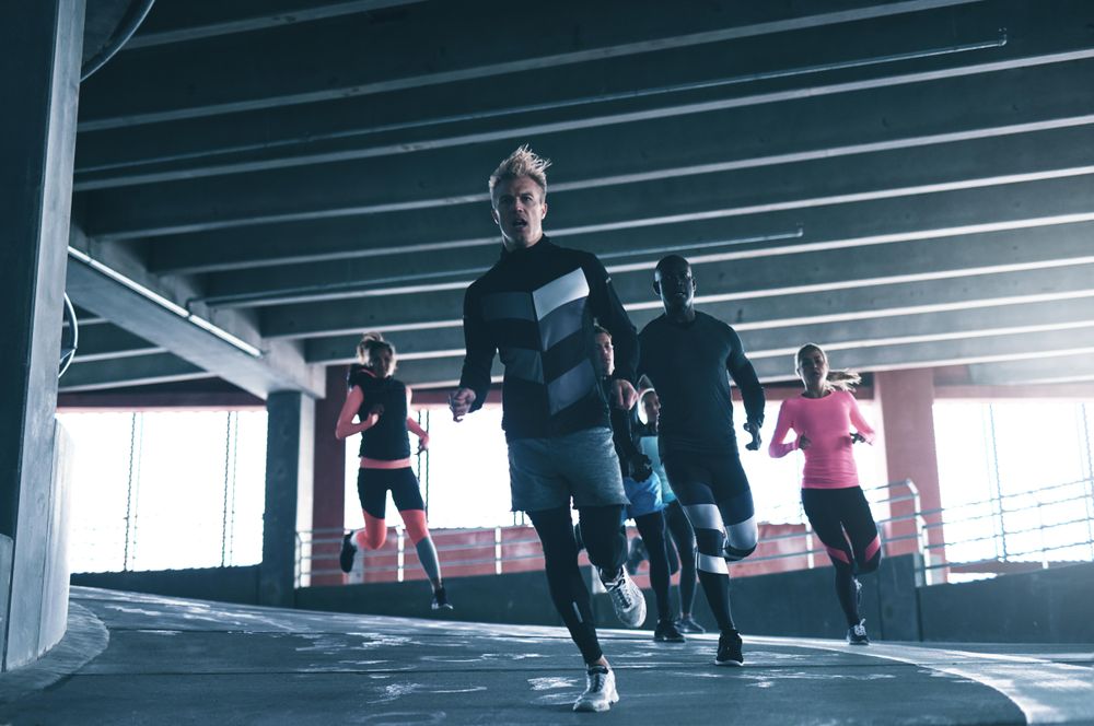 Group of people running around a curve on the track