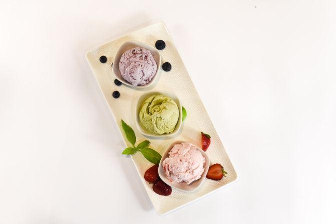 Top view of three small bowls of colorful ice cream