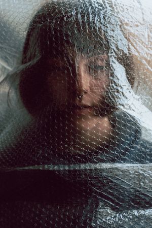 Woman entangled in bubble wrap