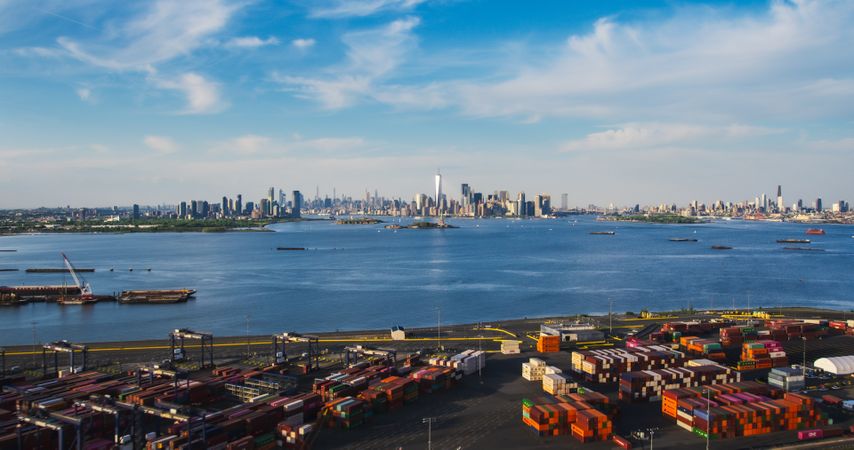 Aerial View of Manhattan Architecture. Panorama of New York City and Jersey City From a Helicopter, Showing Office Buildings and Skyscrapers. Camera Flies Over a Harbour Area with Shipping Containers