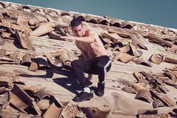 Man trying descending from uneven tiled roof