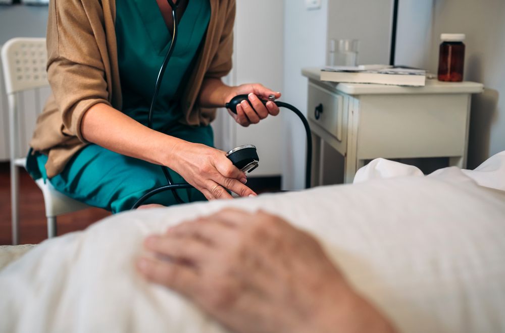 Caregiver checking blood pressure to a woman