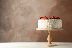 Berry cream cake on wooden table. Delicious dessert