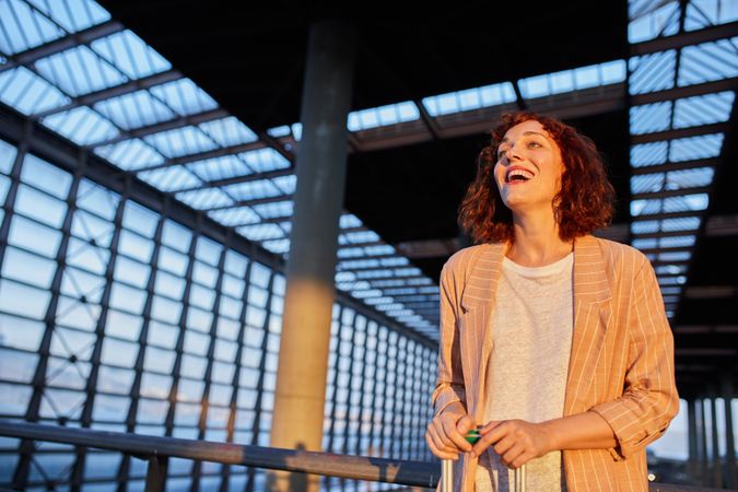 Smiling attractive young female at station
