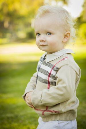 Adorable Blonde Baby Boy Outdoors at the Park.