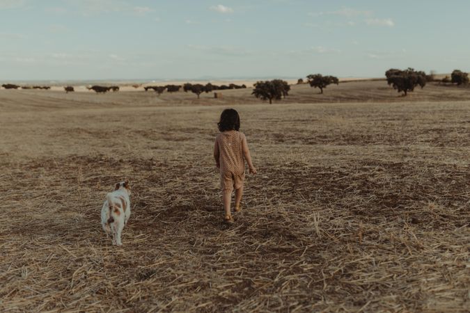 Child and her dog in a field