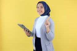 Portrait of Smiling Young Asian Muslim Woman Wearing Hijab Holding Digital Tablet and Magnetic Pen