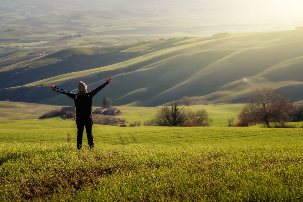 Traveling person walking on green rural road