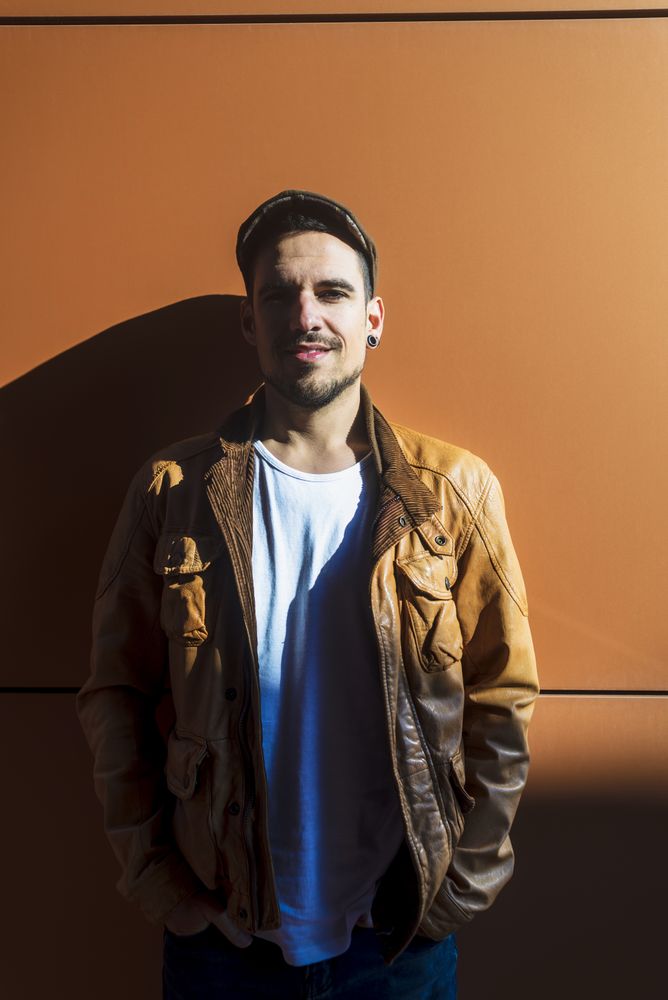 Confident guy leaning on wall