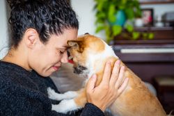 Woman face to face with cute small dog