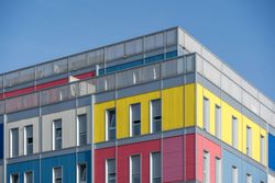 Facade of modern multicolored building with narrow windows