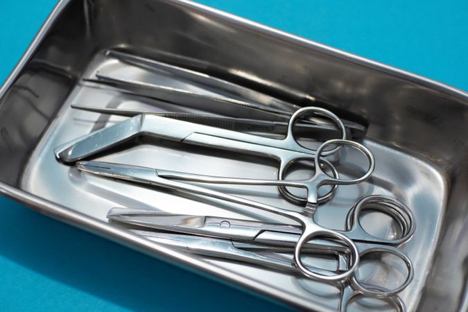 Surgical Instrument in a tray with blue background