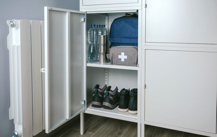 Emergency backpack and first aid kit kept in a closet