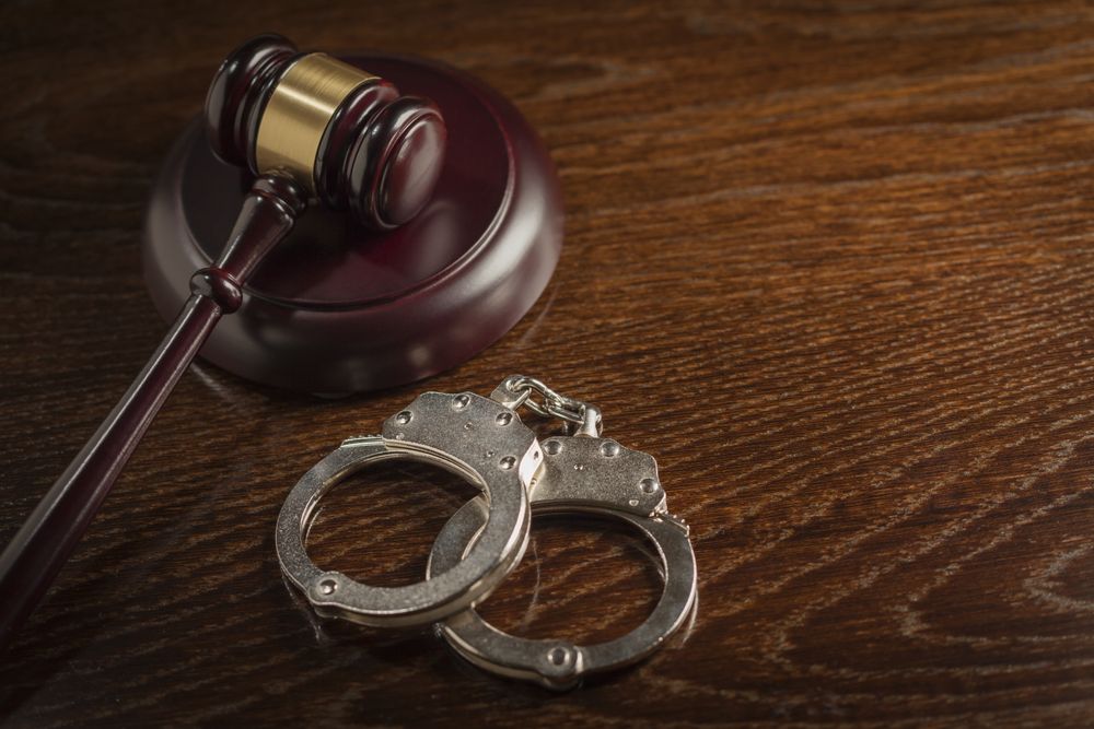 Gavel and Pair of Handcuffs on Table