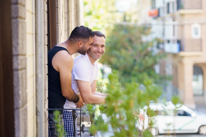 Male couple standing on their patio together