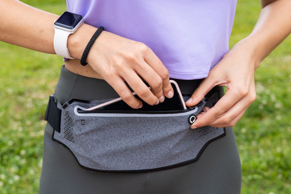 Runner woman getting fanny pack ready for running