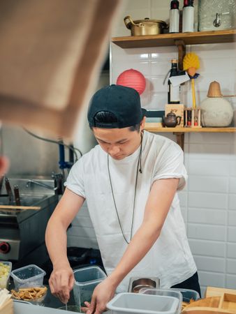 Asian cook working in kitchen