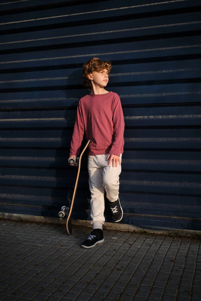 Little skater resting near wall