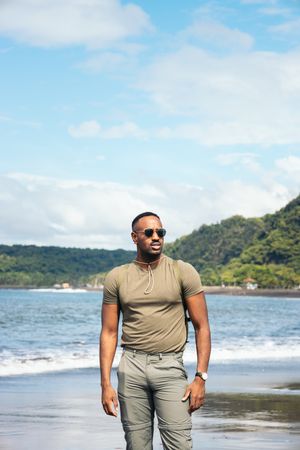 Black man with clothes in the beach