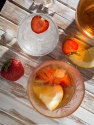 Glass of refreshing strawberry drink in daylight