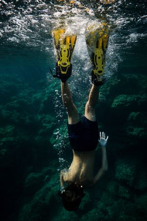 Unrecognizable man plunging into seawater