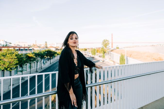 Trendy female standing on urban background