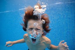 Furious boy yelling in swimming pool