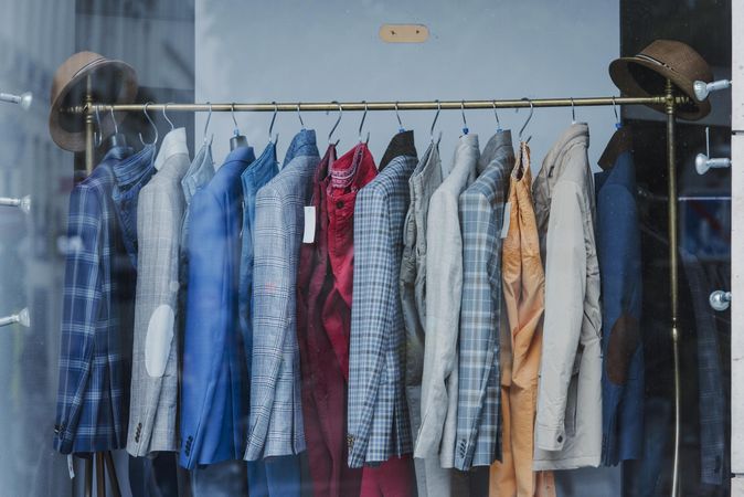 Clothes rack of colorful suits in fashion store