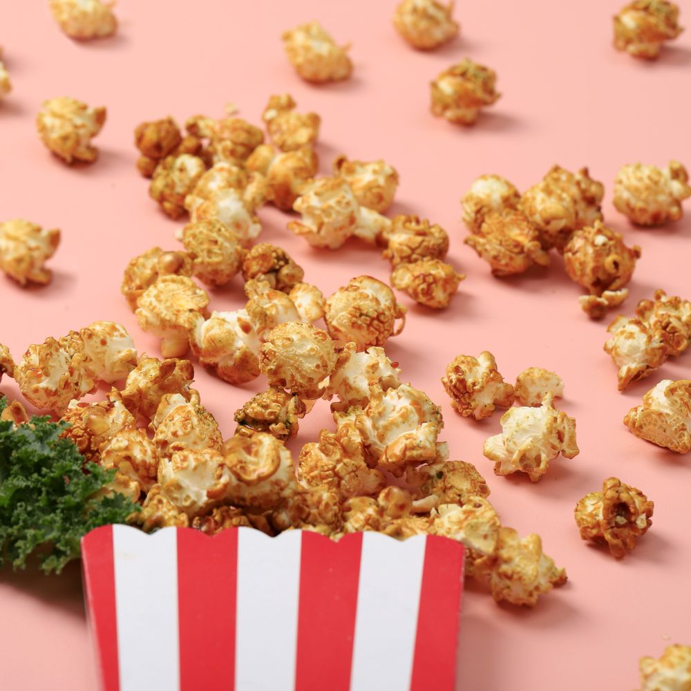 Stripe Box with Popcorn on Pink Background