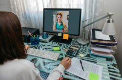 Woman talking on video call with her doctor