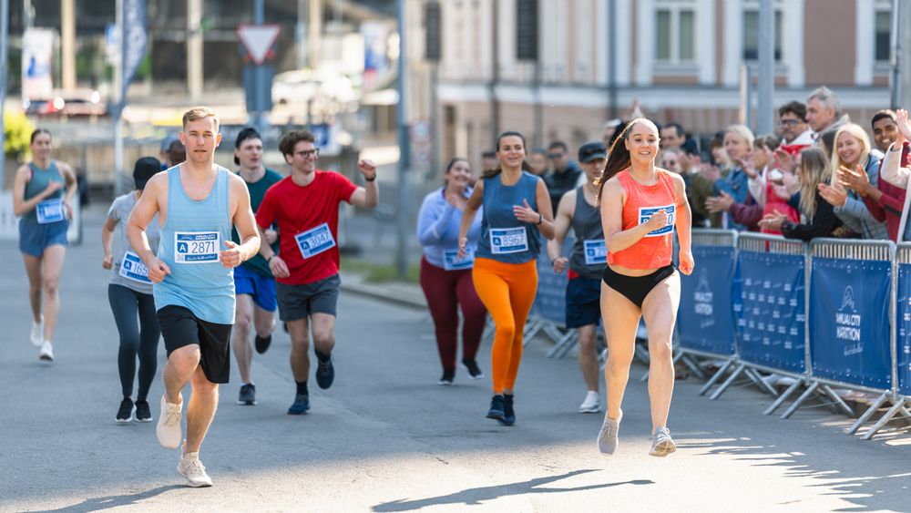 Smiling Group of People Participating in a City Marathon.