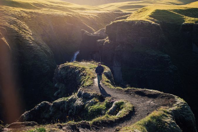 Man walking up from edge of cliff