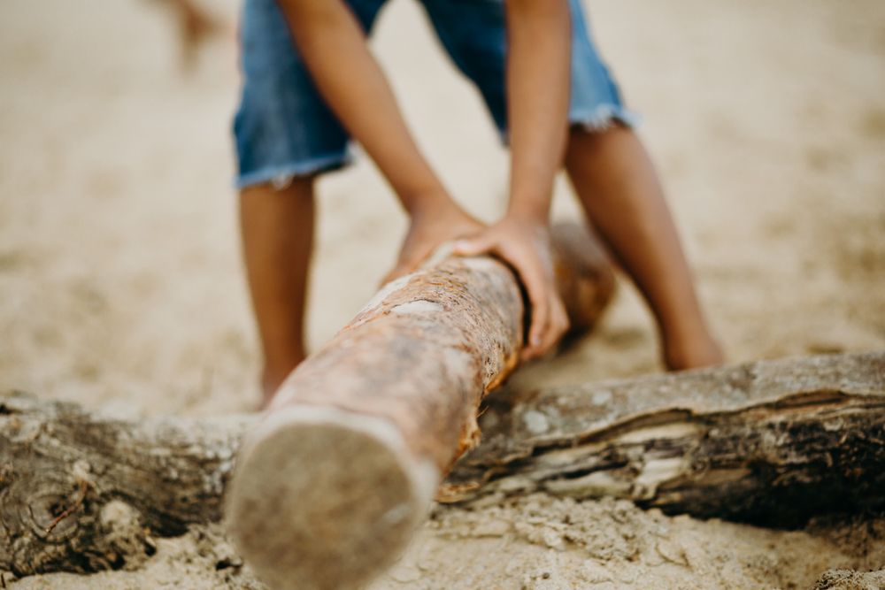 Crop Black boy playing on beach