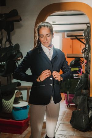 Woman preparing for horse riding