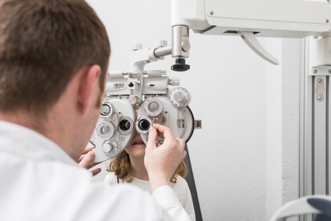 Optician testing a girl's eyes