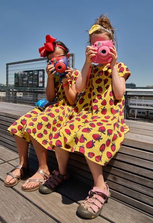 Two girls with toy cameras visit New York City's High Line, New York City, New York