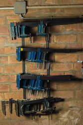 Set of carpentry clamps on metal shelves