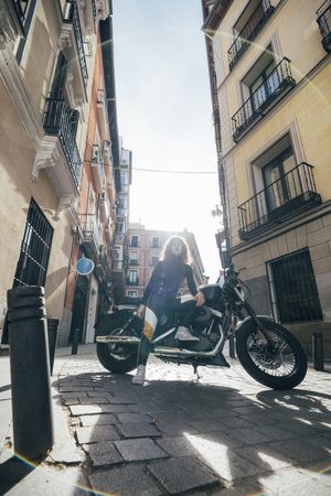 Young woman in custom motorbike