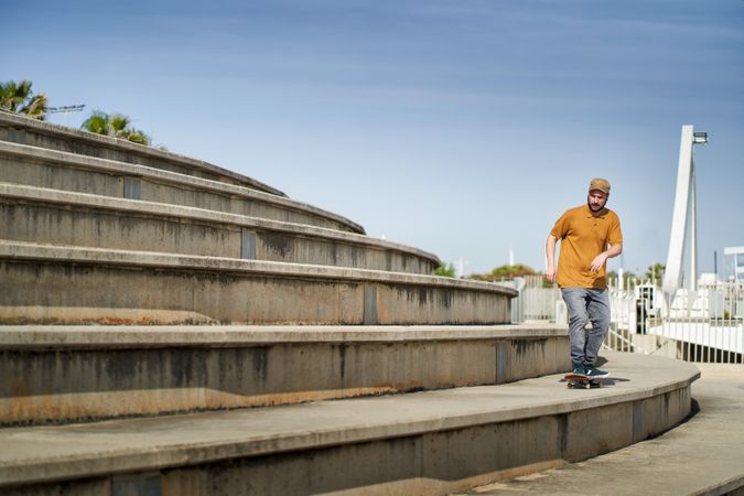 A young man skating on a bleachers