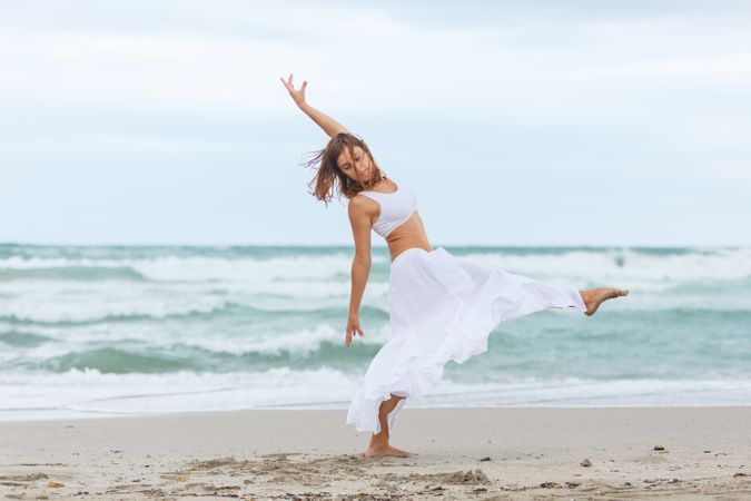 woman dancing near sea