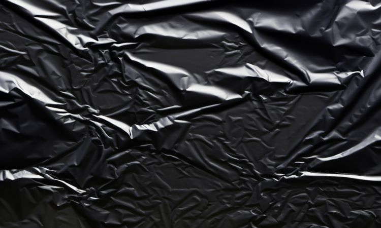 dark crumpled and creased plastic poster texture background