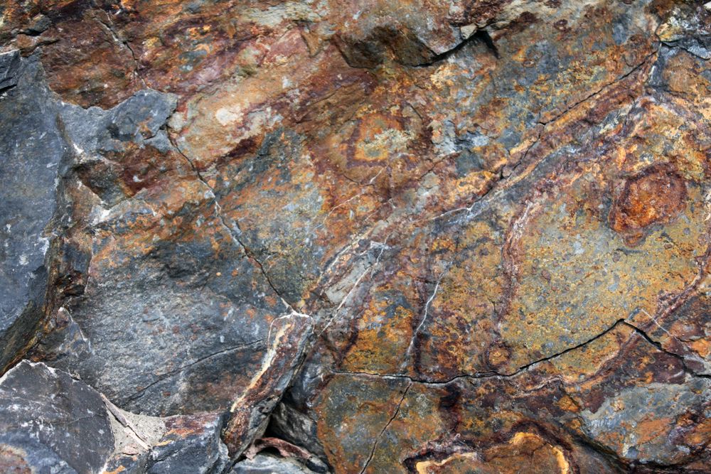 Dark brown and yellow tones on rock face