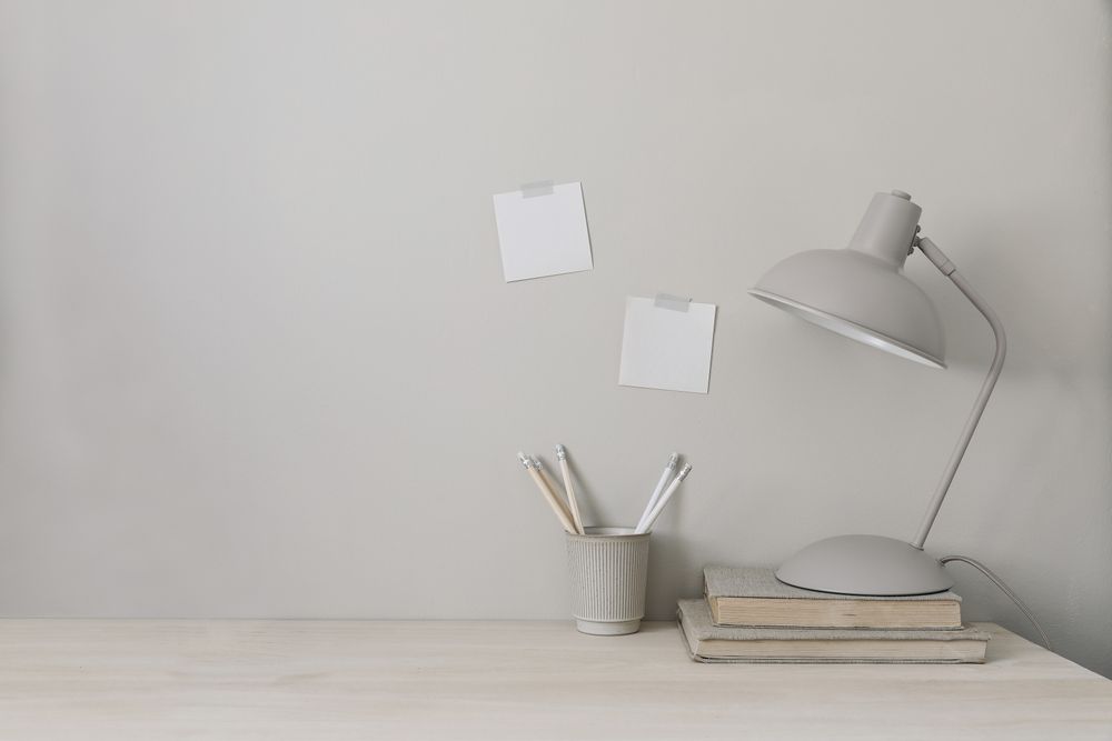 Wooden desk with lamp, books and cup holder for pencils