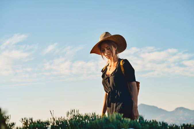 Woman traveler in straw hat walking