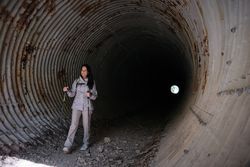 Hispanic woman standing in tunnel
