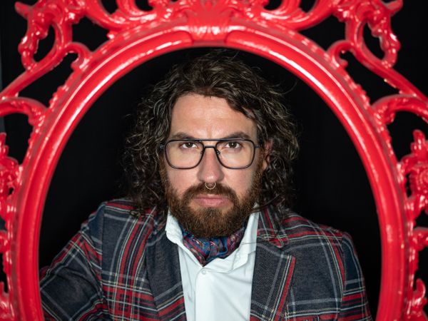 Portrait of imposing man in red art frame