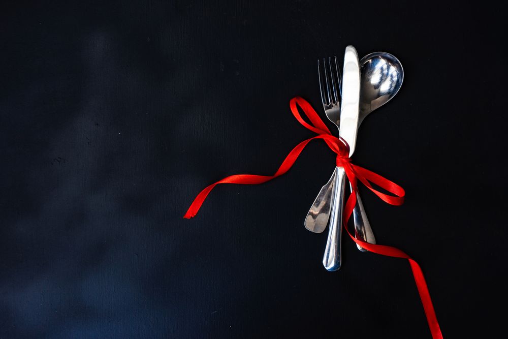 Top view of thin cutlery set on ornate plate