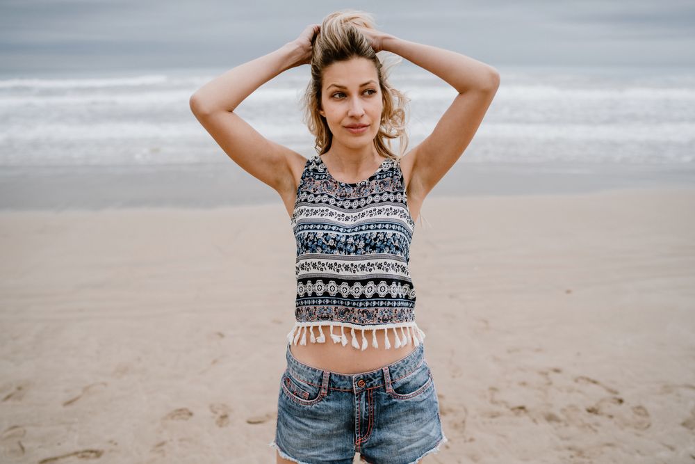 Happy female posing on sandy beach
