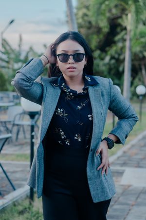 Confident young woman in stylish blazer outdoor portrait session